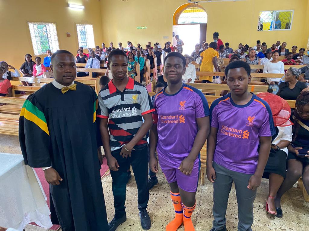Pastor Chavrone Clarke stands ready to baptize the young men who have decided to give their hearts to God. Photo credit: Dwayne Scott